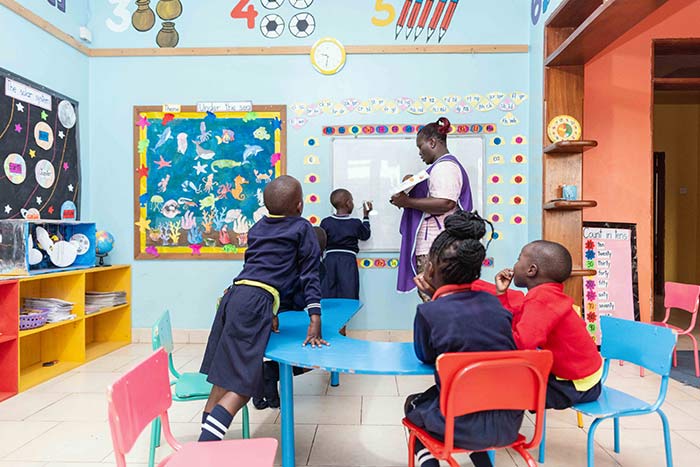 Kindergarten teacher instructing a student